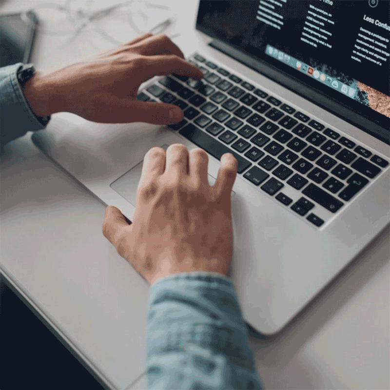 Person typing on a laptop keyboard